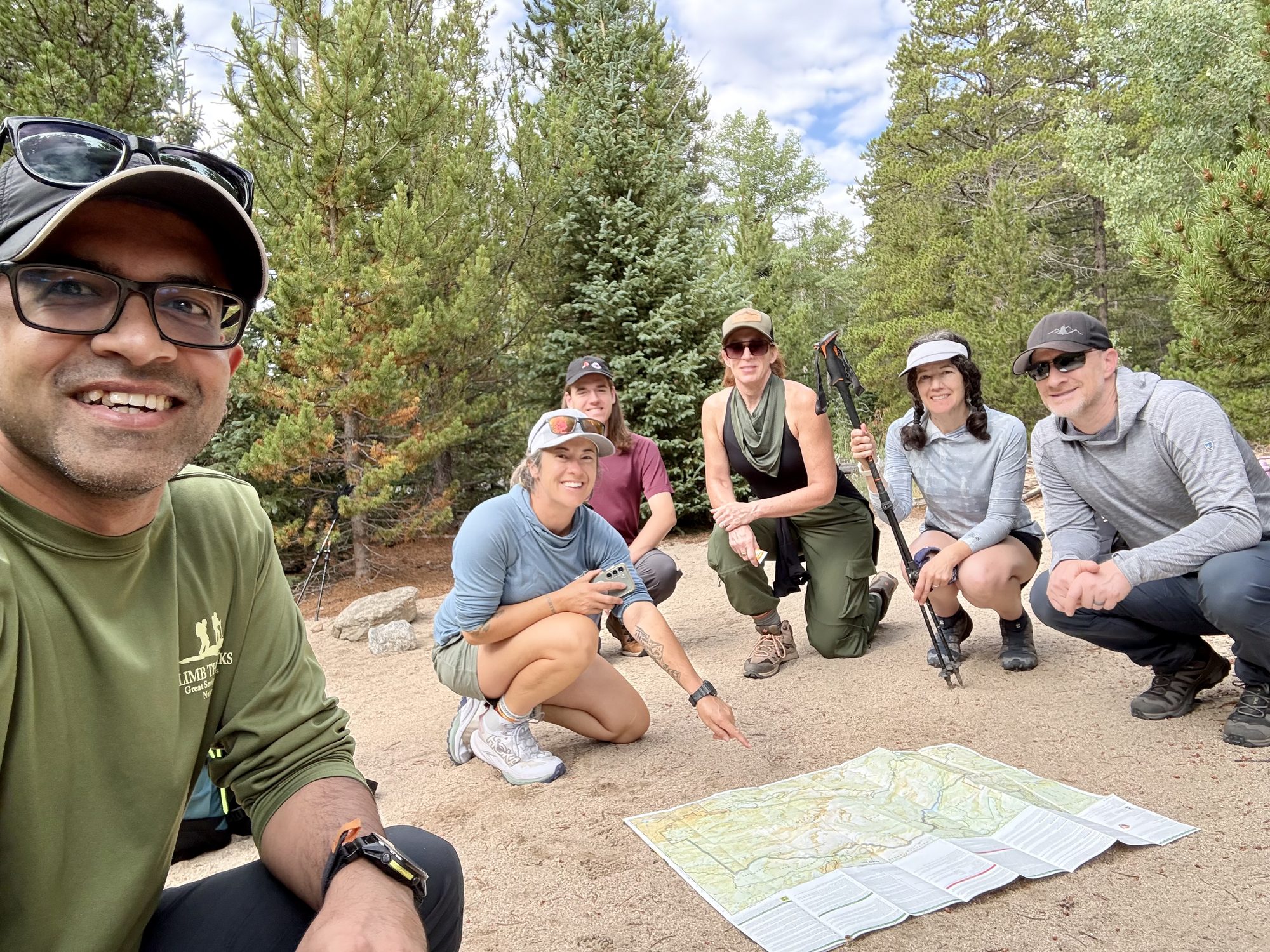 The morning map briefing, spread out on the dirt
