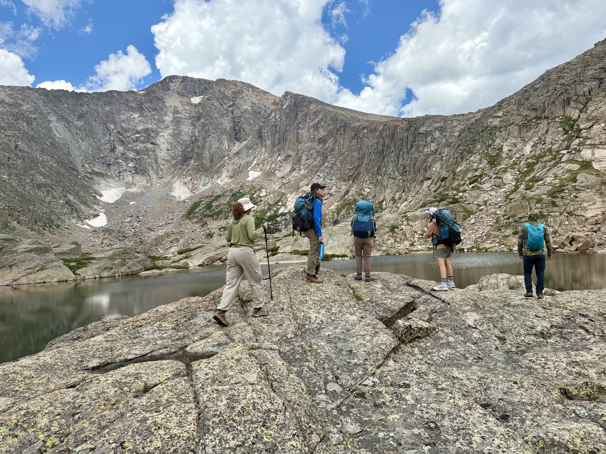 Crossing the rock slabs above a tarn, packs light for once.